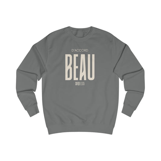 A dark gray crewneck sweatshirt with a beige graphic print on the front reading 'D'ACCORD BEAU' on a solid white background.