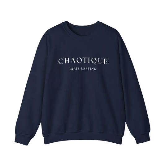 Navy blue sweatshirt on a white background featuring a “Chaotique Mais Raffiné” graphic text print.
