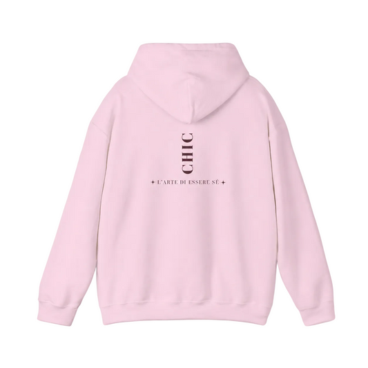 A light pink pullover hoodie featuring a dark brown vertical CHIC back graphic and French-inspired typography, photographed from behind against a clean light gray studio background.