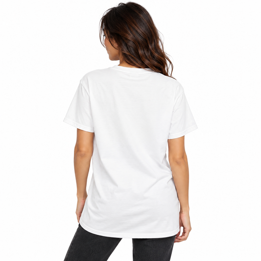 Back view of a female model wearing a white UNSNAKEBLY T-shirt with a long relaxed fit and dark jeans.