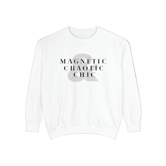 A white crewneck sweatshirt with a graphic print on the chest reading 'MAGNETIC CHAOTIC CHIC' in black serif text over a large gray ampersand symbol.