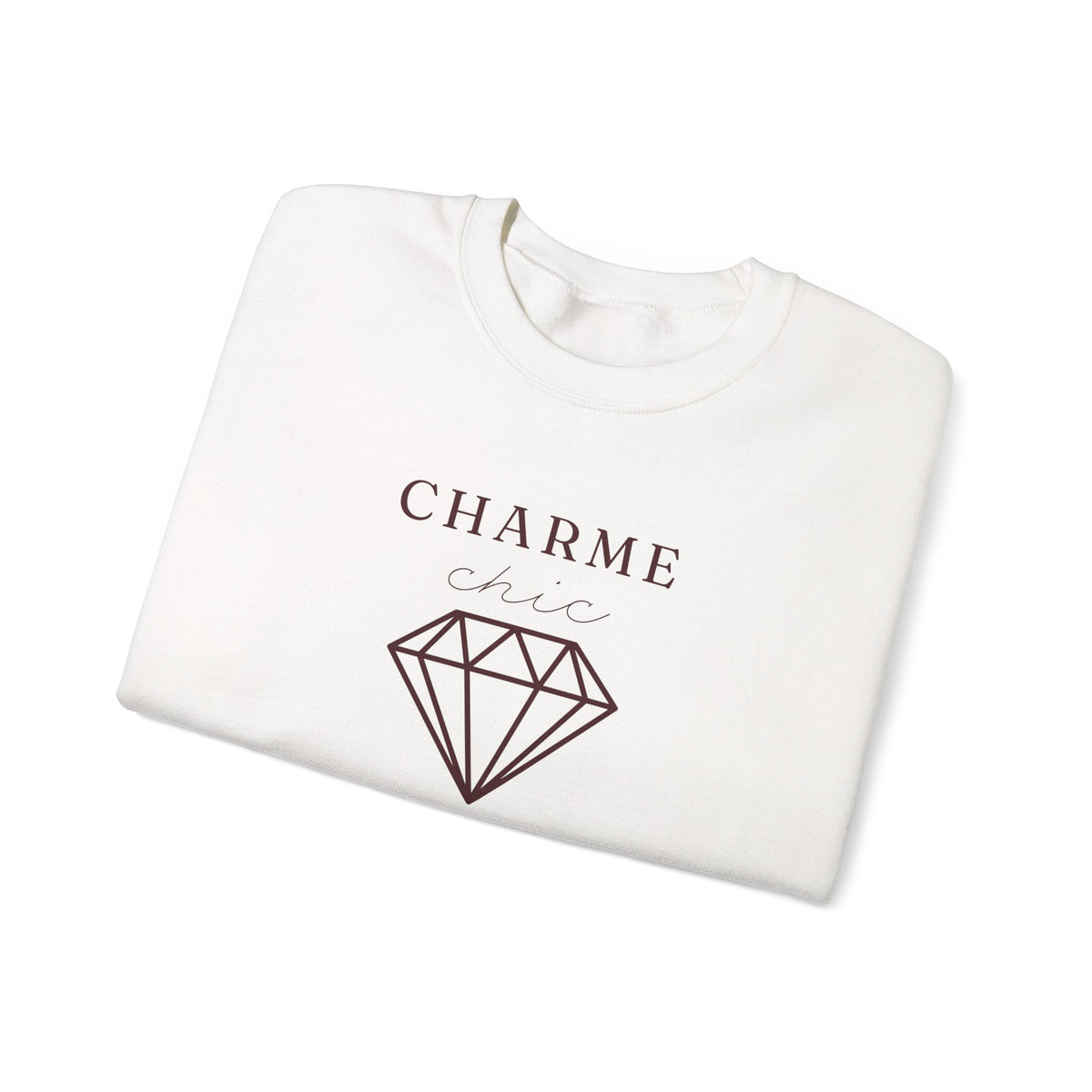 A folded white crewneck sweatshirt featuring a burgundy graphic print that reads 'CHARME chic' above a diamond outline, set against a plain white background.