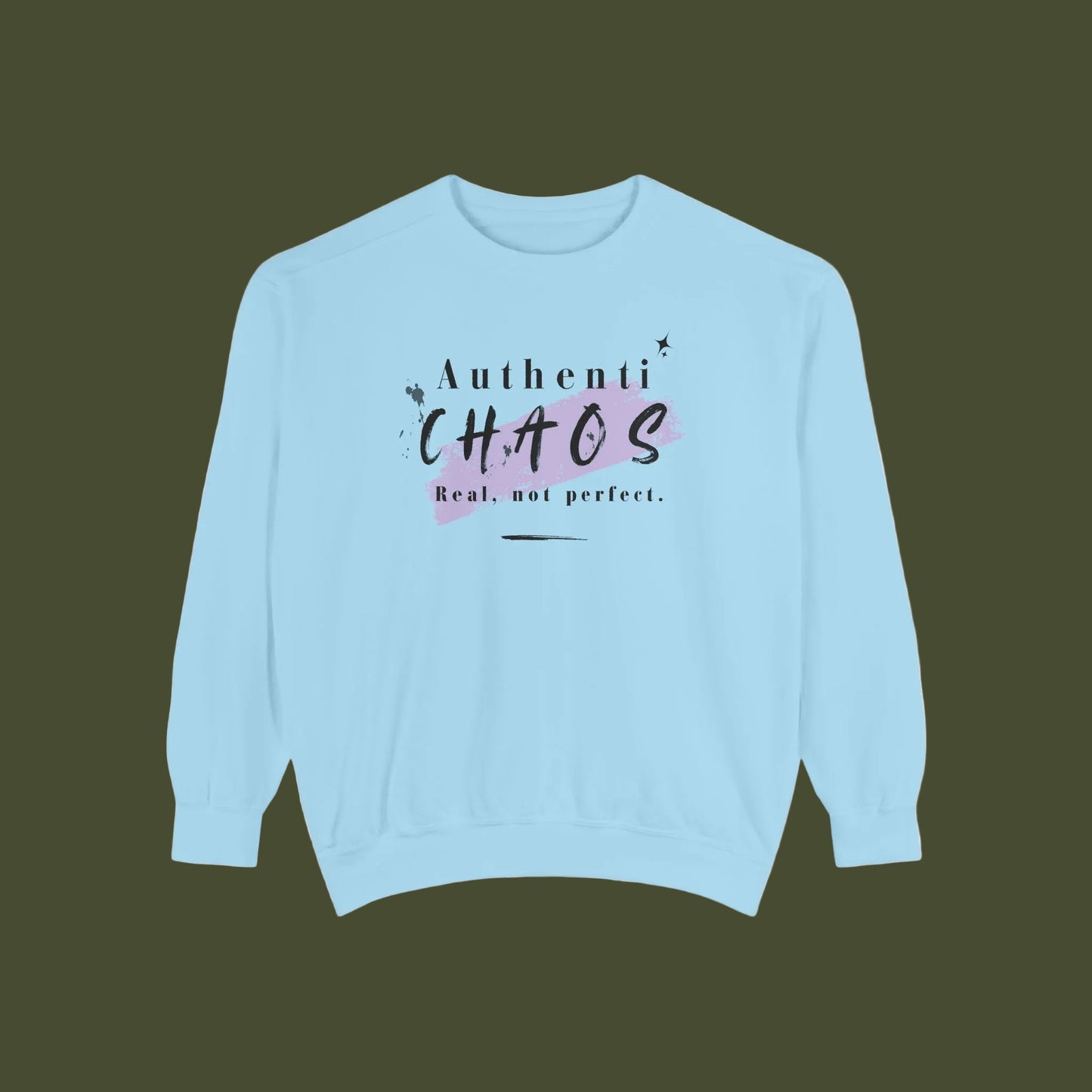 A light blue crewneck sweatshirt with a graphic on the chest that reads 'Authenti CHAOS Real, not perfect.' in black and dark purple lettering over a pink paint splatter background.