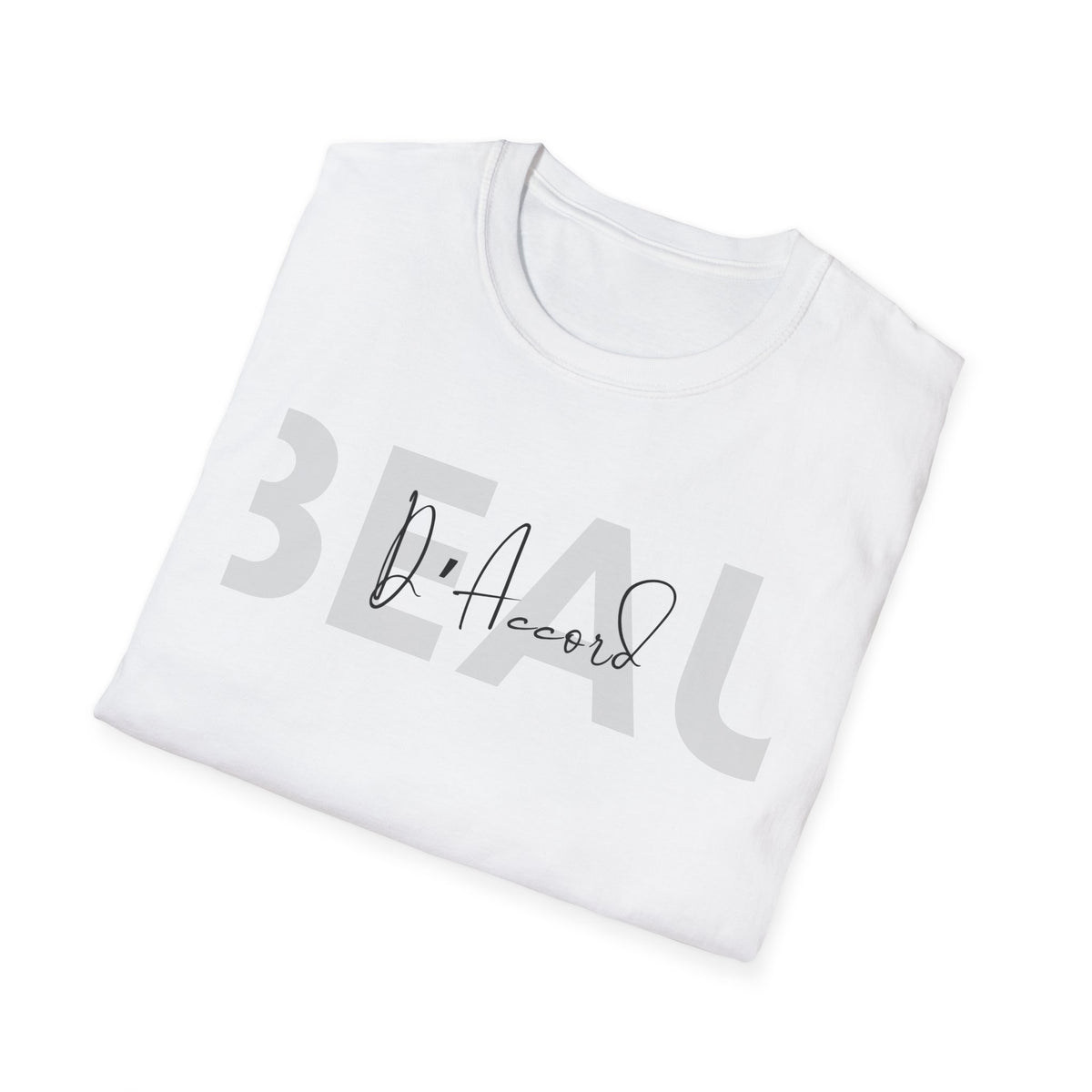 A folded white t-shirt with a graphic print on the front. The print features the word 'BEAU' in a large, semi-transparent gray sans-serif font, overlaid with a black cursive signature reading 'D'Accord'.