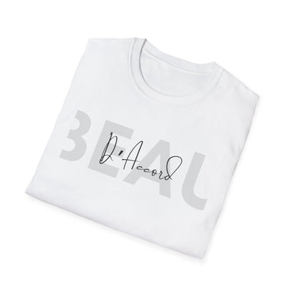 A folded white t-shirt with a graphic print on the front. The print features the word 'BEAU' in a large, semi-transparent gray sans-serif font, overlaid with a black cursive signature reading 'D'Accord'.