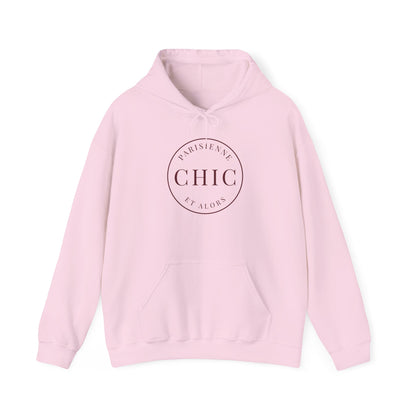 A light pink hoodie featuring a dark circular “PARISIENNE CHIC ET ALORS” graphic on the front, displayed against a clean white background.