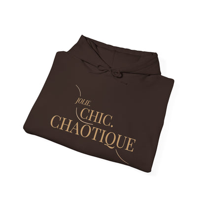 Folded brownhoodie with frog graphic and 'jolie. Chic. Chaotique' text on a white background
