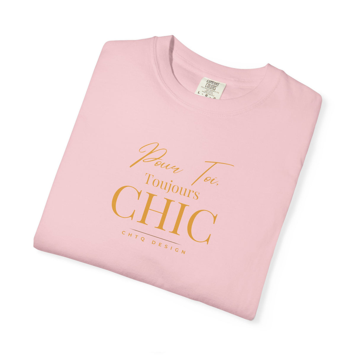 Folded pink CHTQ Design T-shirt with gold “Pour Toi. Toujours CHIC” typography on the front.