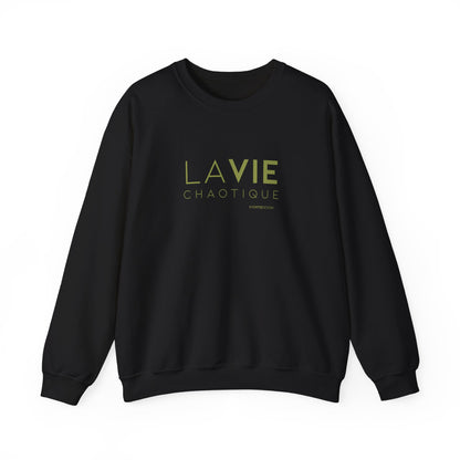 An black crewneck sweatshirt with “LA VIE CHAOTIQUE” printed in olive green and “BY CHTQ DESIGN” beneath the graphic, displayed against a clean white background.