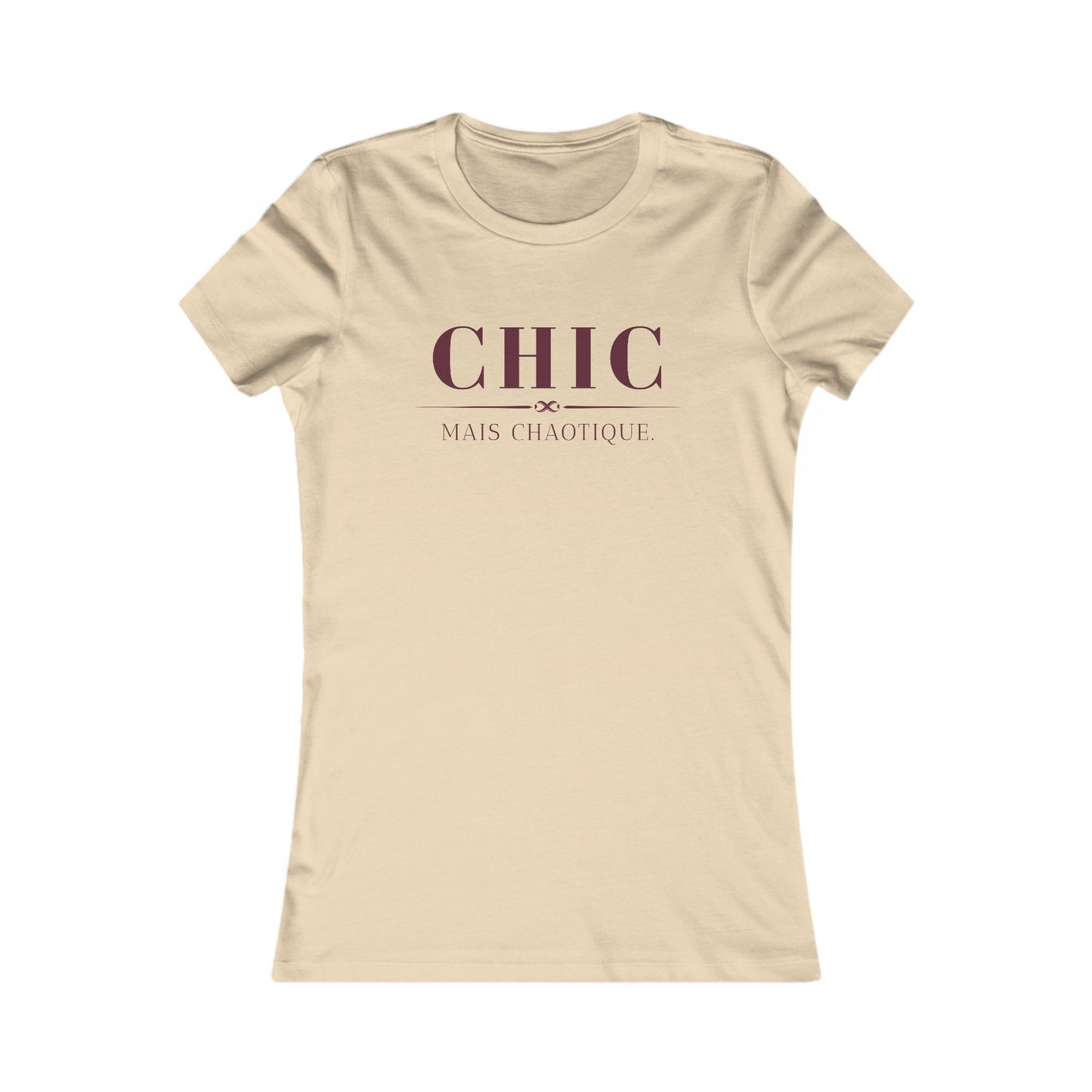 A beige short-sleeve crewneck t-shirt with a dark maroon graphic print on the chest reading 'CHIC MAIS CHAOTIQUE'.