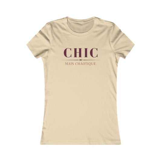 A beige short-sleeve crewneck t-shirt with a dark maroon graphic print on the chest reading 'CHIC MAIS CHAOTIQUE'.