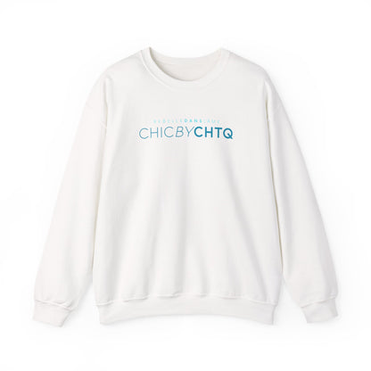 A white crewneck sweatshirt with text reading “CHIC BY CHTQ” and “REBELLE DANS L’ÂME” printed across the chest.