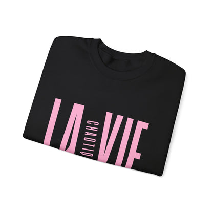 Folded black LA VIE CHAOTIQUE sweatshirt featuring light pink graphic