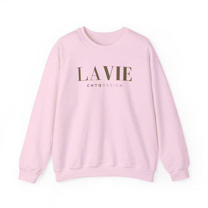 A light pink crewneck sweatshirt featuring a gold “LA VIE” graphic with smaller “CHTQ DESIGN” text underneath, displayed against a clean white background.
