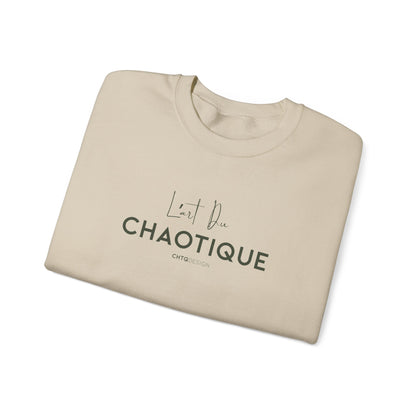 A folded beige crewneck t-shirt with dark gray text reading 'L'art Du CHAOTIQUE' and 'CHTQ DESIGN' printed on the front, displayed on a clean white background.