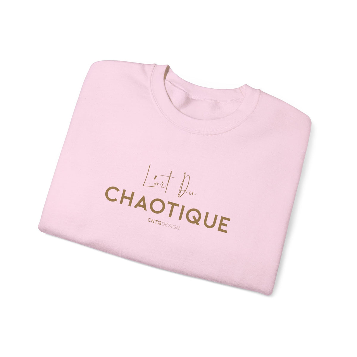 A folded light pink t-shirt with metallic rose gold text reading 'L'Art Du CHAOTIQUE' and 'CHTQ DESIGN' printed on the front, displayed on a clean white background.