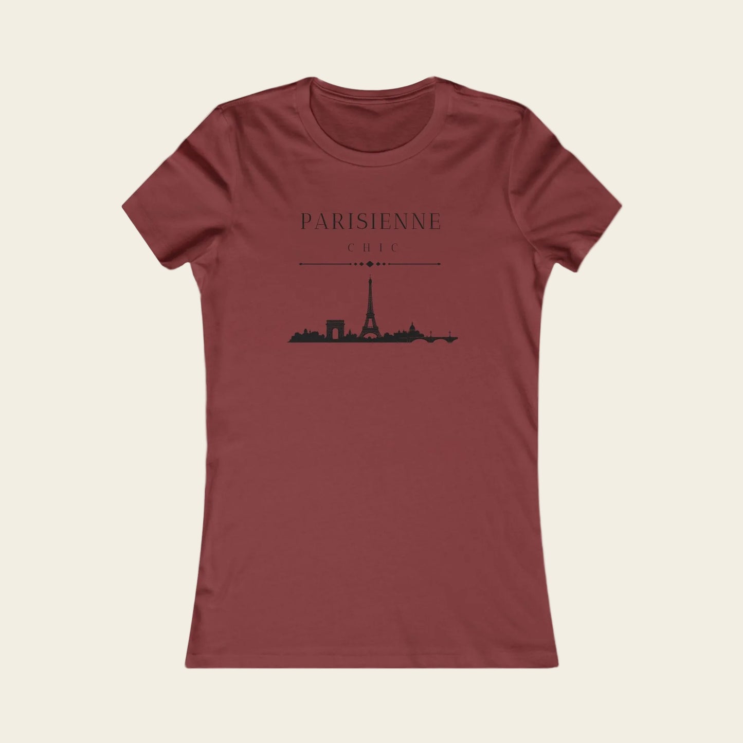 A women's short-sleeve crewneck t-shirt in a dusty brick red color, featuring a black graphic print of the Paris skyline with the text 'PARISIENNE' and 'CHILI' on the front.