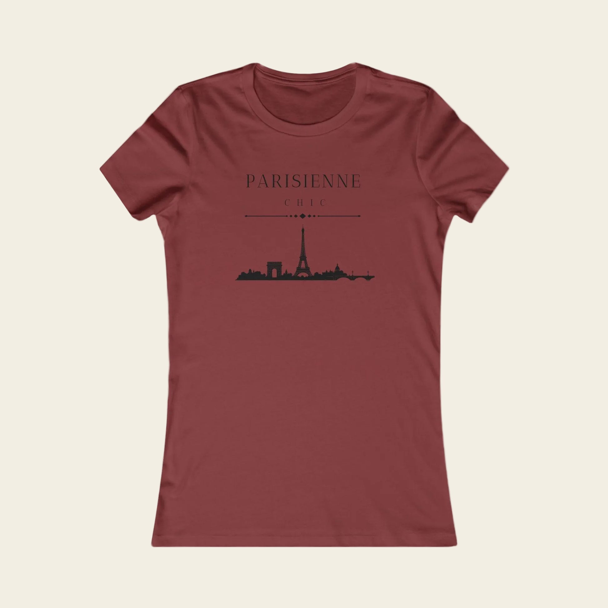 A women's short-sleeve crewneck t-shirt in a dusty brick red color, featuring a black graphic print of the Paris skyline with the text 'PARISIENNE' and 'CHILI' on the front.