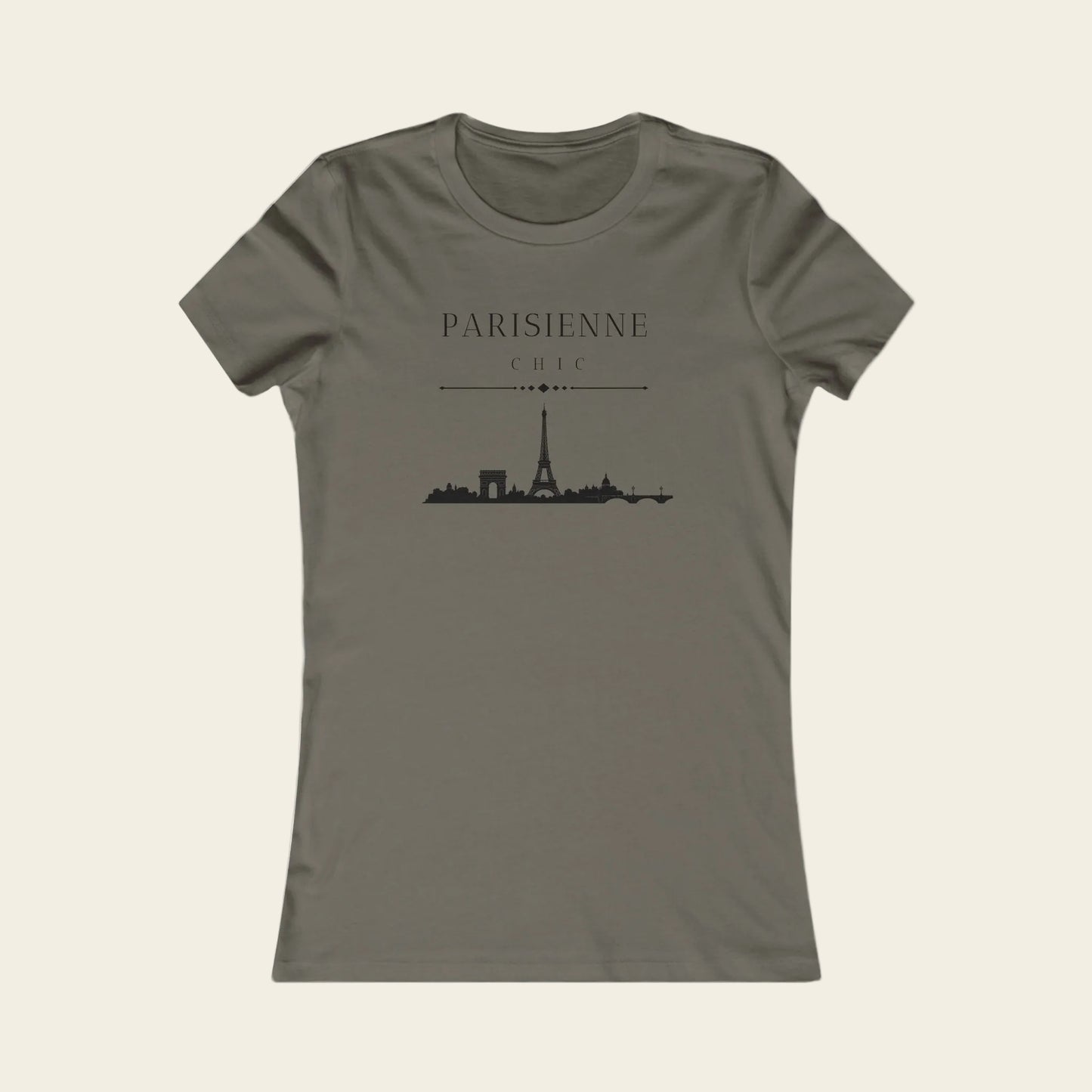 A women's short-sleeve crewneck t-shirt in a muted taupe-gray color, featuring a black graphic print of the Paris skyline with the text 'PARISIENNE' and 'CHIC' above it.