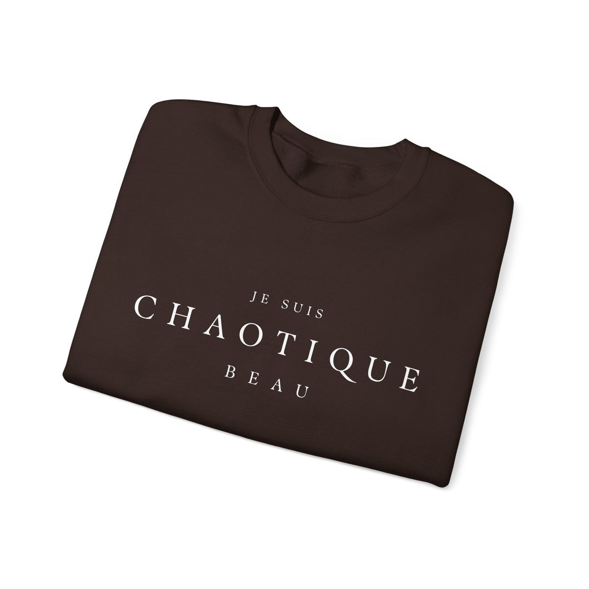 Folded brown crewneck sweatshirt with the text 'JE SUIS CHAOTIQUE BEAU' printed in white across the chest