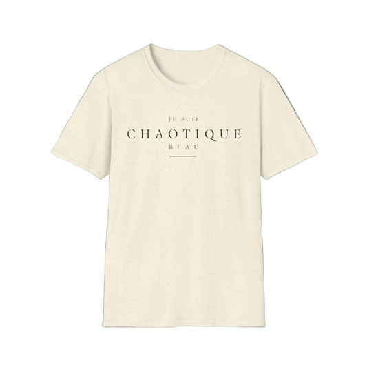 A light beige short-sleeve crewneck t-shirt with the French text 'JE SUIS CHAOTIQUE BEAU' printed in black across the chest, displayed on a clean white background.