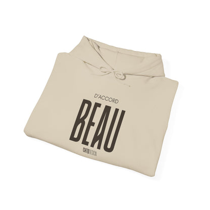 A folded beige hoodie with a black graphic print reading 'D'ACCORD BEAU' on a clean white background.