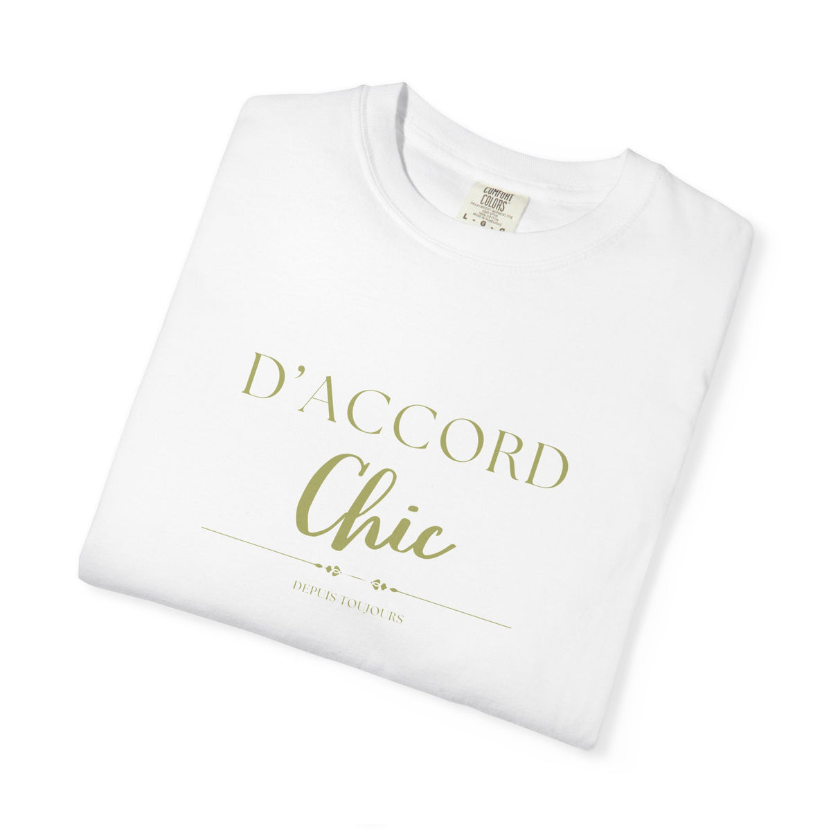 A folded white crewneck t-shirt with 'D'ACCORD Chic' printed in a metallic gold foil font on the front, displayed on a clean white background.