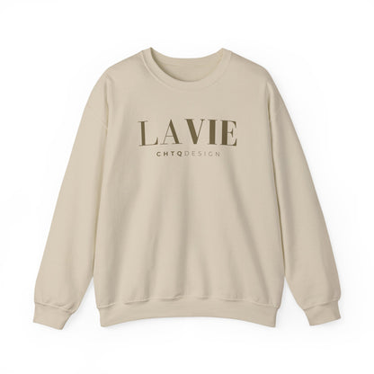 A beige crewneck sweatshirt featuring a gold “LA VIE” graphic with smaller “CHTQ DESIGN” text underneath, displayed against a clean white background.