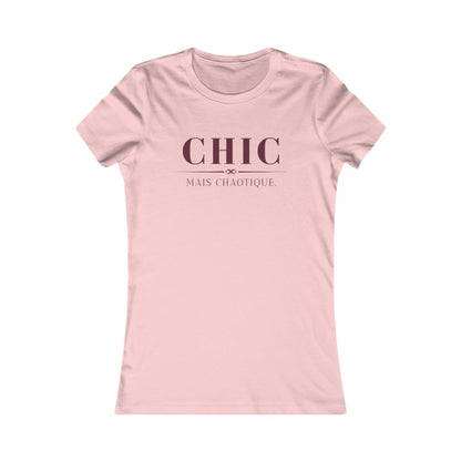 A light pink short-sleeve crewneck t-shirt with the French phrase 'CHIC MAIS CHAOTIQUE' printed in dark pink on the chest, displayed on a clean white background.