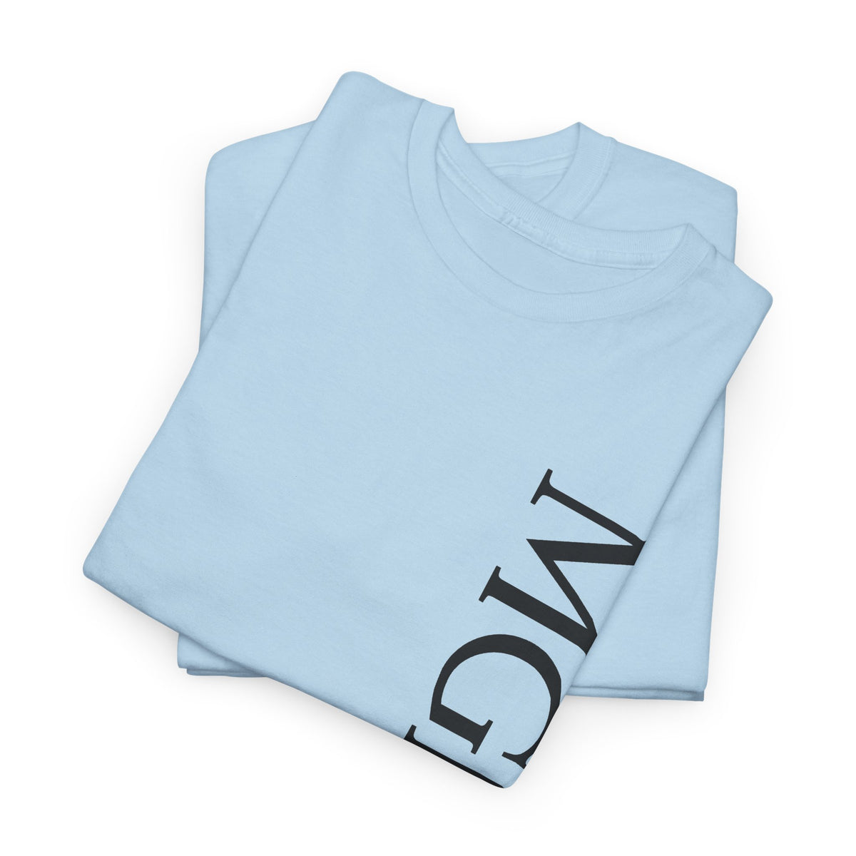 A light blue folded t-shirt with a large black graphic print of the letters 'MGNFQ' on the front, displayed on a clean white background.
