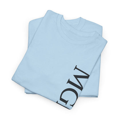 A light blue folded t-shirt with a large black graphic print of the letters 'MGNFQ' on the front, displayed on a clean white background.