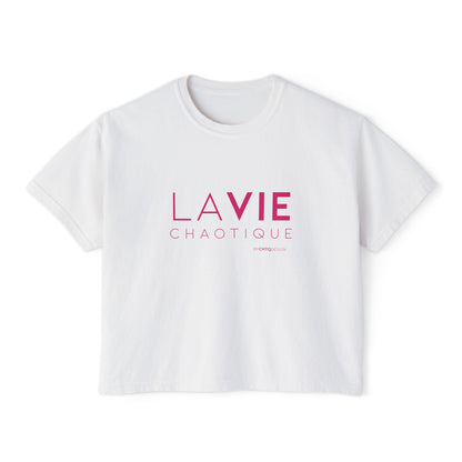A white short-sleeve boxy T-shirt with a slightly cropped fit, featuring “LA VIE CHAOTIQUE” typography in pink on the front with a small CHTQ Design signature underneath, displayed against a clean white background.