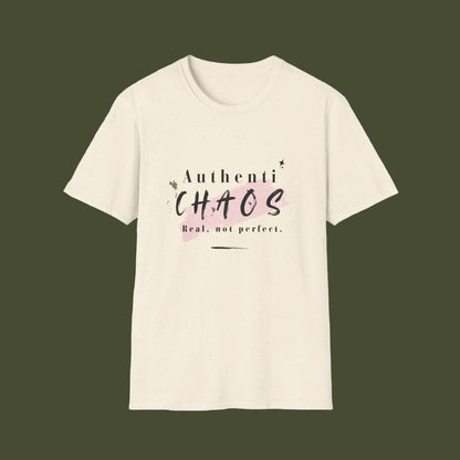 An off-white short-sleeve crewneck t-shirt featuring a graphic print on the front with the words 'AuthentiCHAOS' in black and pink lettering, and the phrase 'Real, not perfect.' underneath.