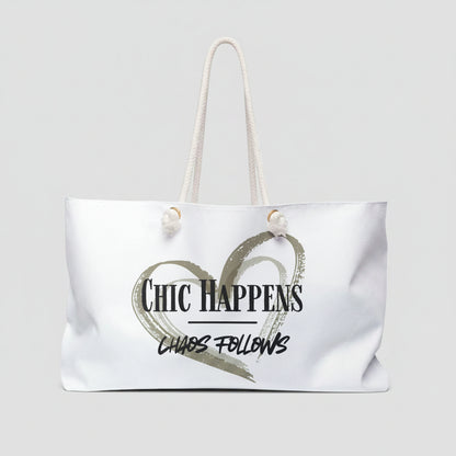 A white canvas tote bag with white rope handles, featuring a printed graphic of a textured heart and the text 'Chic Happens' and 'Chaos Follows' on the front.
