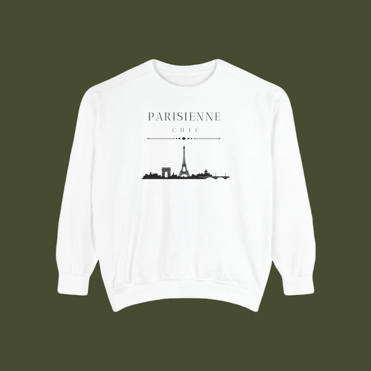 A white crewneck sweatshirt featuring a black graphic print of the Paris skyline with the text 'PARISIENNE CHIC' above it, displayed on a clean white background.