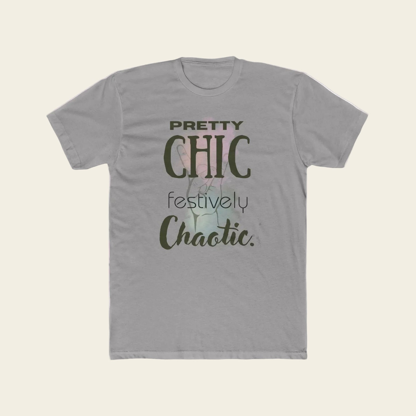 A light gray crewneck t-shirt featuring a graphic print on the front with the text 'PRETTY CHIC festively Chaotic.' in dark olive green and black lettering over a faint pastel background illustration.