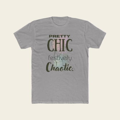 A light gray crewneck t-shirt featuring a graphic print on the front with the text 'PRETTY CHIC festively Chaotic.' in dark olive green and black lettering over a faint pastel background illustration.