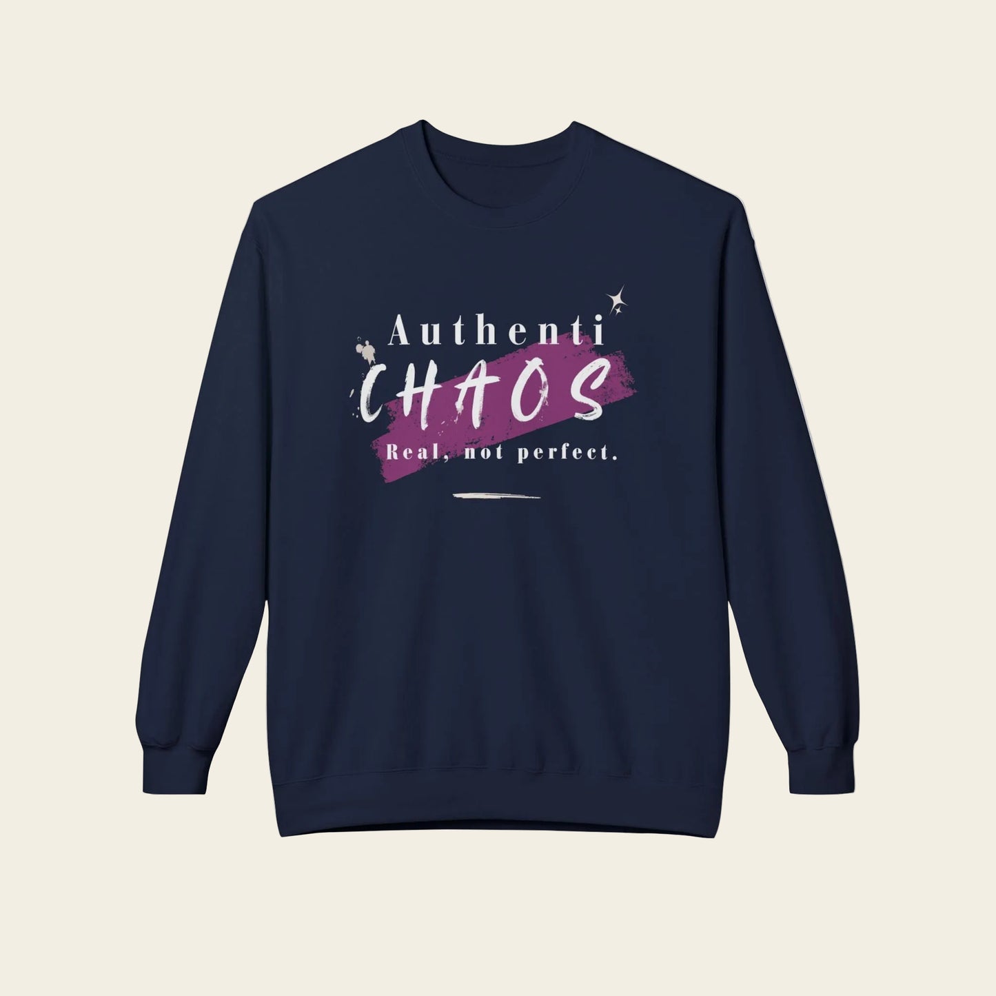 A navy blue crewneck sweatshirt with a graphic on the chest that reads 'Authenti CHAOS Real, not perfect.' in white and purple, displayed on a clean white background.