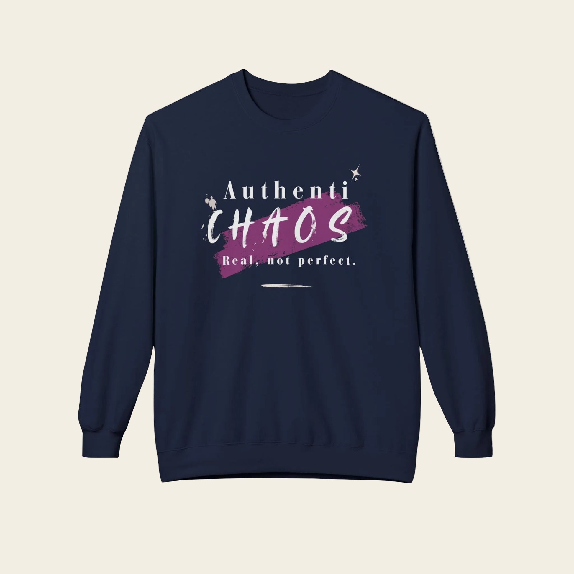 A navy blue crewneck sweatshirt with a graphic on the chest that reads 'Authenti CHAOS Real, not perfect.' in white and purple, displayed on a clean white background.