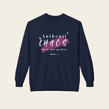 A navy blue crewneck sweatshirt with a graphic on the chest that reads 'Authenti CHAOS Real, not perfect.' in white and purple, displayed on a clean white background.