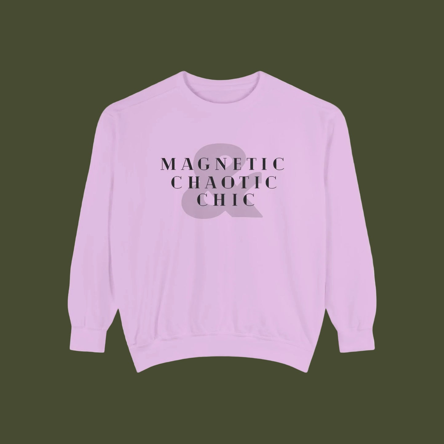 A light purple crewneck sweatshirt with a graphic on the chest that reads 'MAGNETIC CHAOTIC CHIC' in black serif letters over a muted purple ampersand symbol.