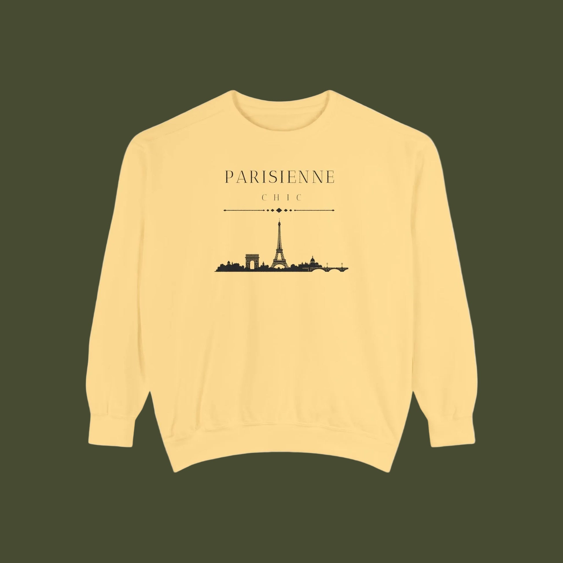 A pale yellow crewneck sweatshirt featuring a black graphic print of the Paris skyline with the text 'PARISIENNE CHIC' above it, displayed on a clean white background.