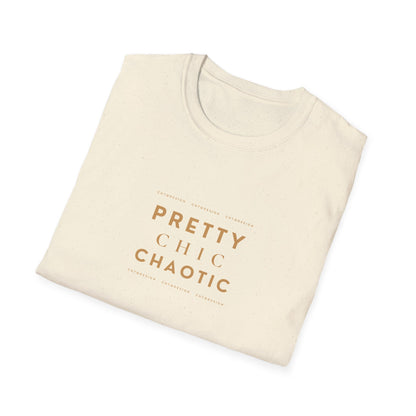 A folded cream-colored cotton t-shirt with a warm brown text graphic reading 'PRETTY CHIC CHAOTIC' on the front, displayed on a clean white background.