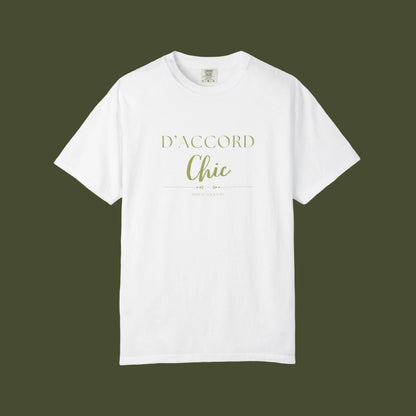A white short-sleeve crewneck t-shirt with 'D'ACCORD Chic' printed in a light olive green font on the chest, displayed against a solid white background.