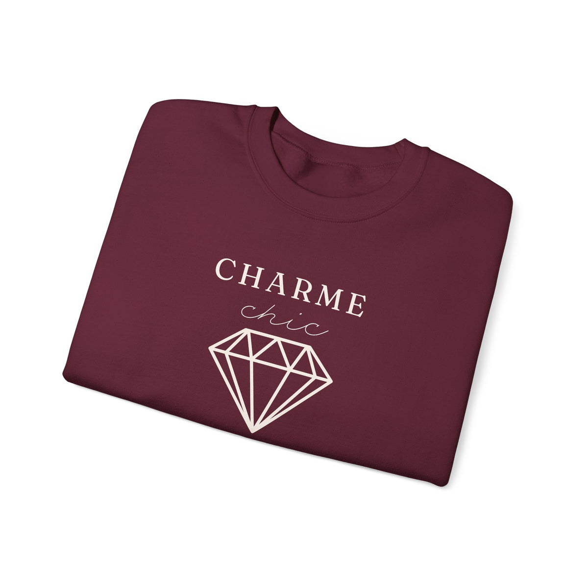 A folded maroon crewneck sweatshirt featuring a light graphic print that reads 'CHARME chic' above a diamond outline, set against a plain white background.
