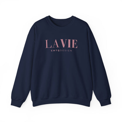 A navy blue crewneck sweatshirt featuring a pink “LA VIE” graphic with smaller “CHTQ DESIGN” text underneath, displayed against a clean white background.