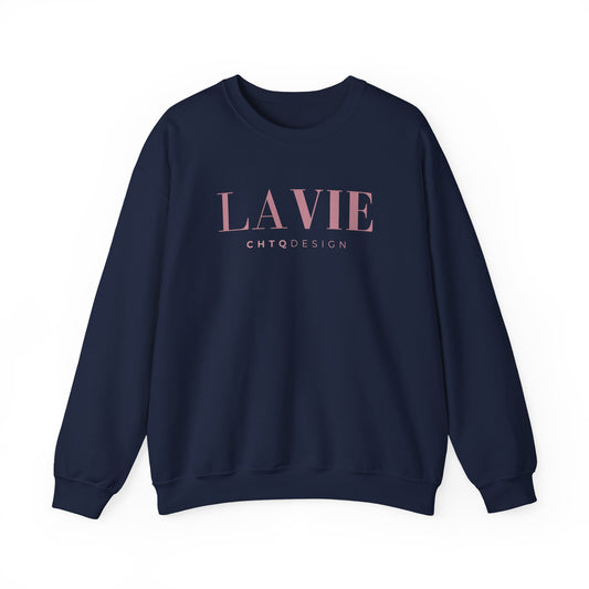 A navy blue crewneck sweatshirt featuring a pink “LA VIE” graphic with smaller “CHTQ DESIGN” text underneath, displayed against a clean white background.