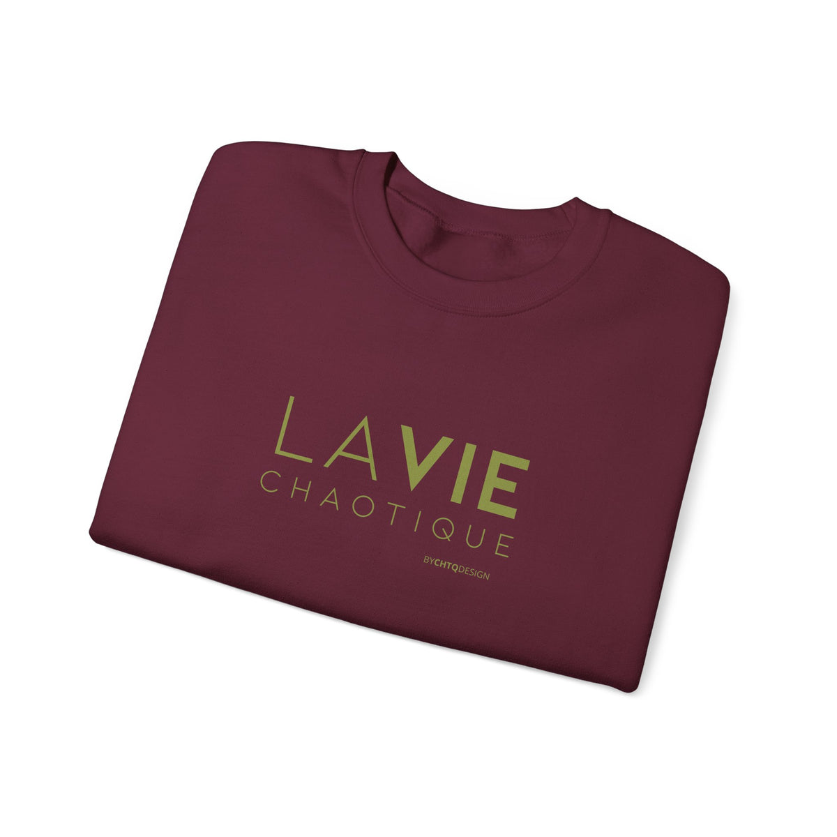 Folded maroon crewneck sweatshirt with “LA VIE CHAOTIQUE” printed in olive green and “BY CHTQ DESIGN” beneath the graphic, displayed against a clean white background.