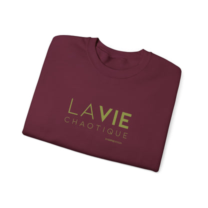 Folded maroon crewneck sweatshirt with “LA VIE CHAOTIQUE” printed in olive green and “BY CHTQ DESIGN” beneath the graphic, displayed against a clean white background.