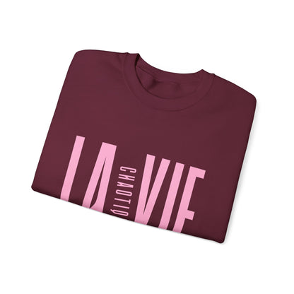 Folded maroon LA VIE CHAOTIQUE sweatshirt featuring light pink typography